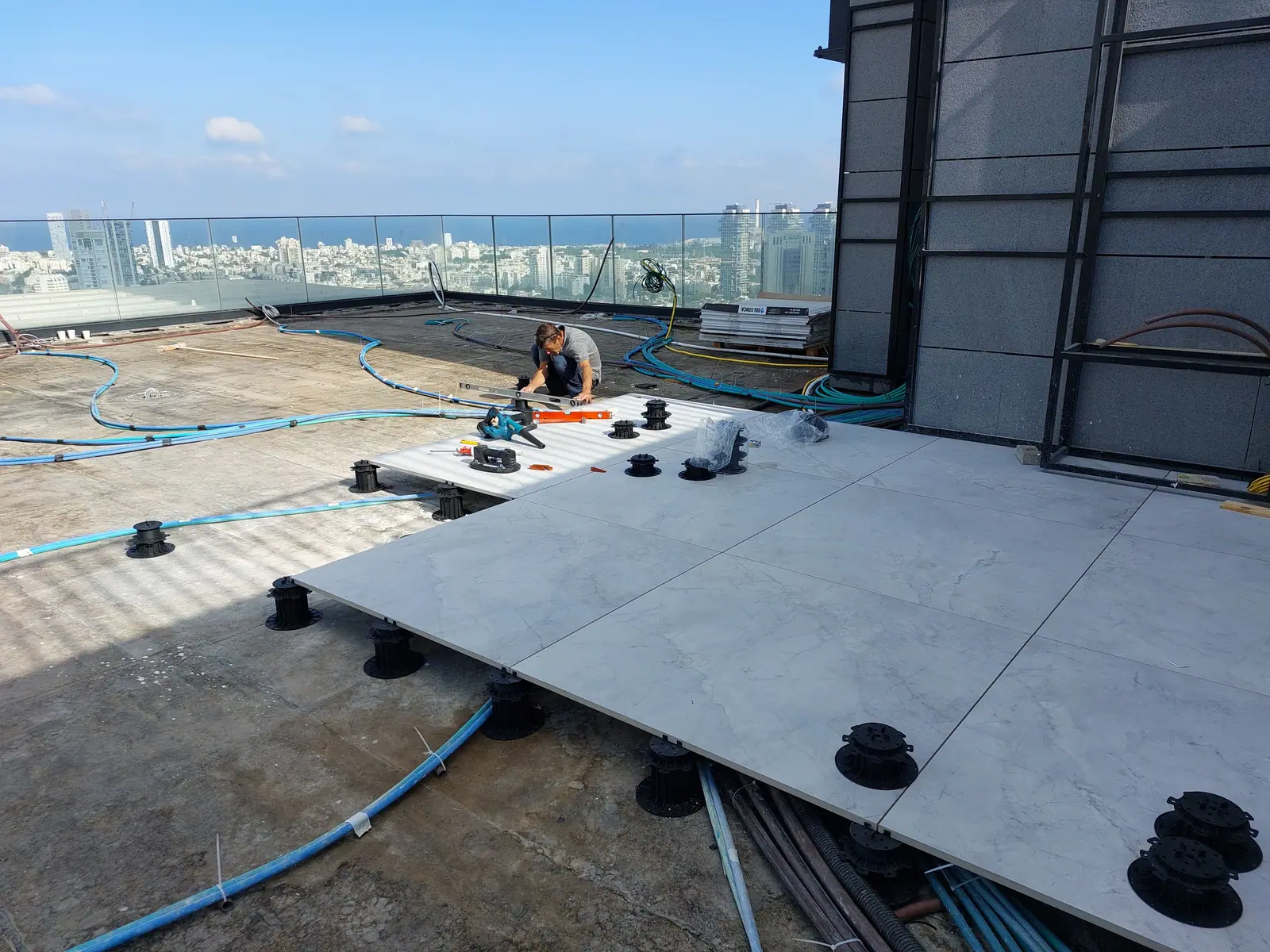 High-rise rooftop deck going down over the roof membrane.