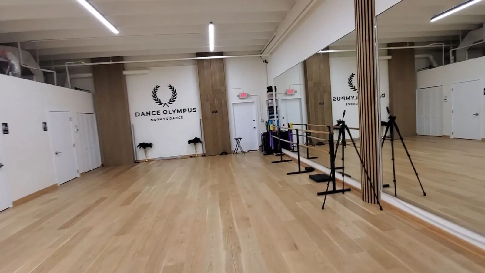Finished hardwood ballroom studio with barres and mirrors in Hollywood, FL.