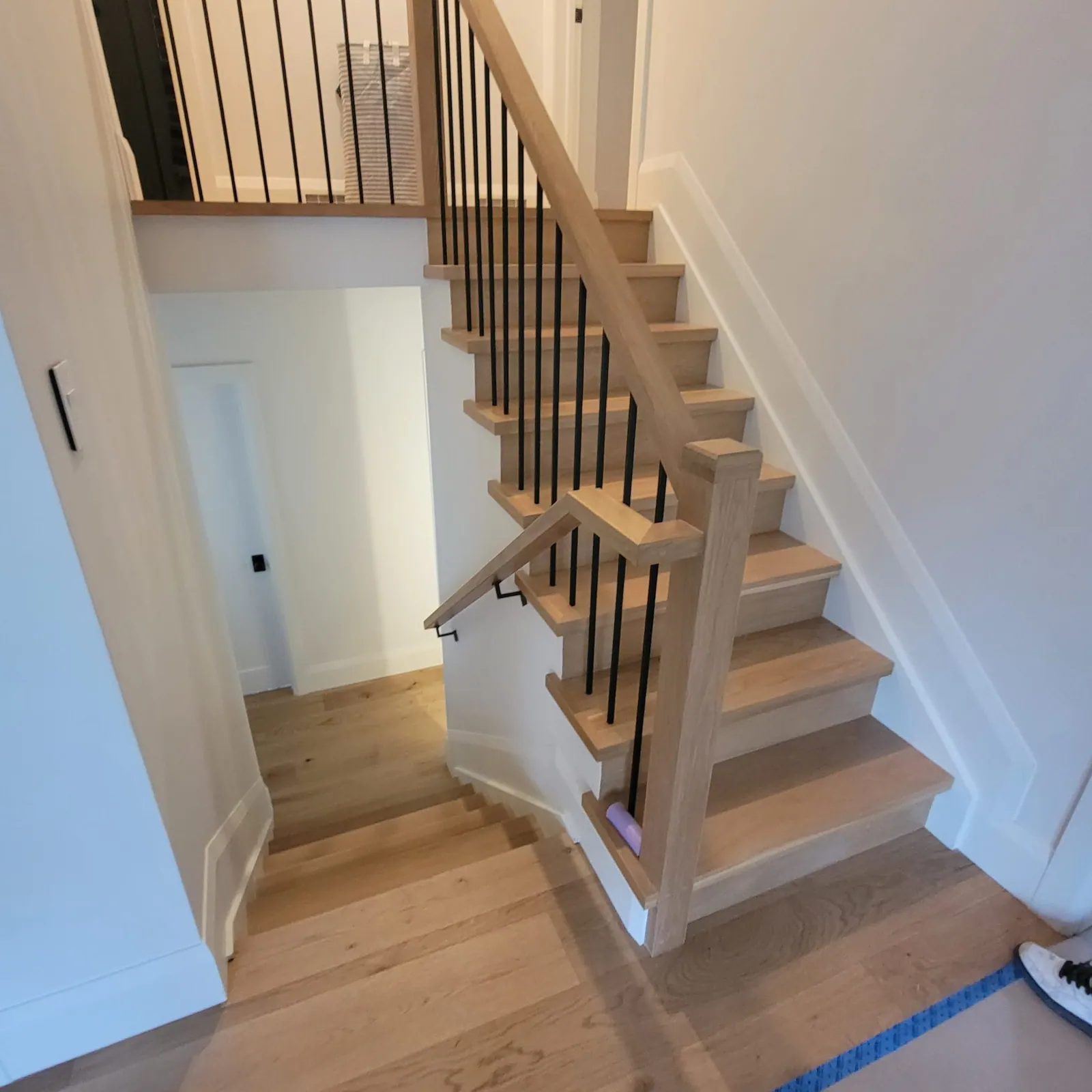 Oak stair with matching floor at the bottom.