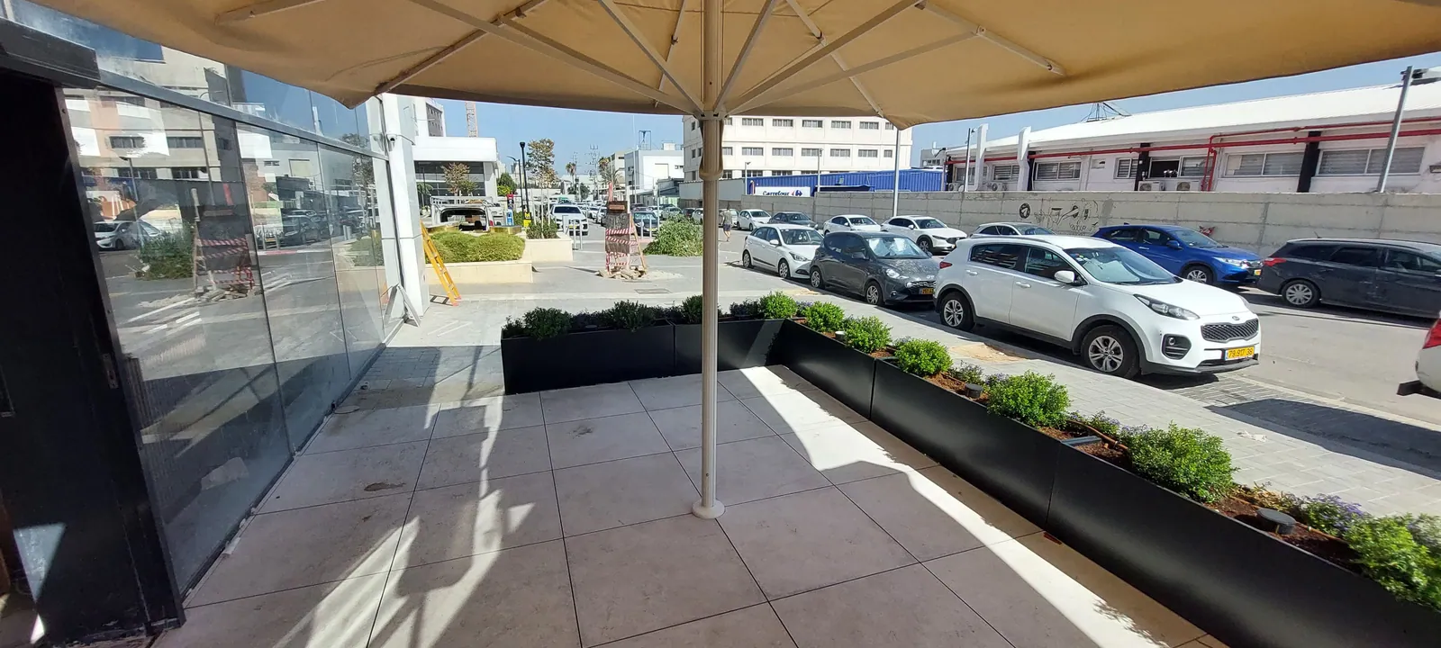 Restaurant patio on a raised paver floor under umbrellas.